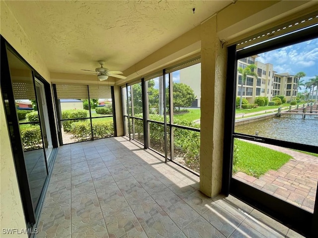 4703 SE 17th Pl Unit 105, Cape Coral, FL 33904 - unfurnished sunroom with ceiling fan, plenty of natural light, a textured ceiling, and a water view