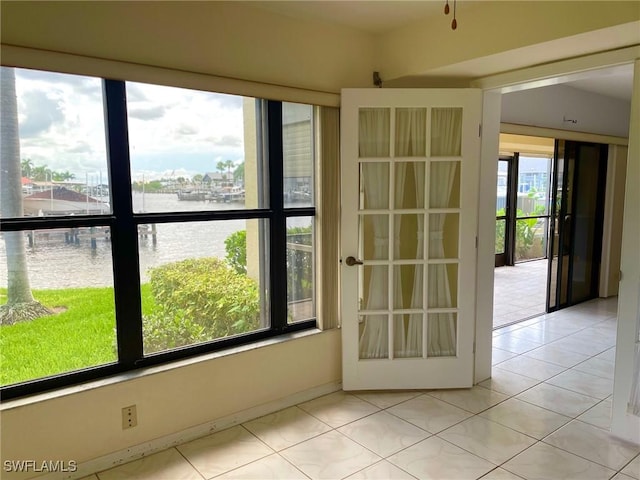 4703 SE 17th Pl Unit 105, Cape Coral, FL 33904 - empty room featuring a water view and light tile patterned floors