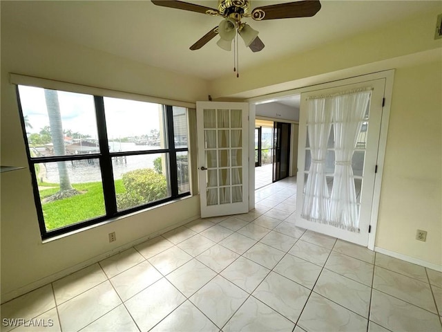 4703 SE 17th Pl Unit 105, Cape Coral, FL 33904 - spare room with healthy amount of natural light, a water view, a ceiling fan, and baseboards