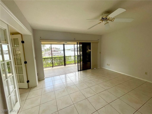 4703 SE 17th Pl Unit 105, Cape Coral, FL 33904 - unfurnished room featuring light tile patterned floors, a ceiling fan, and baseboards