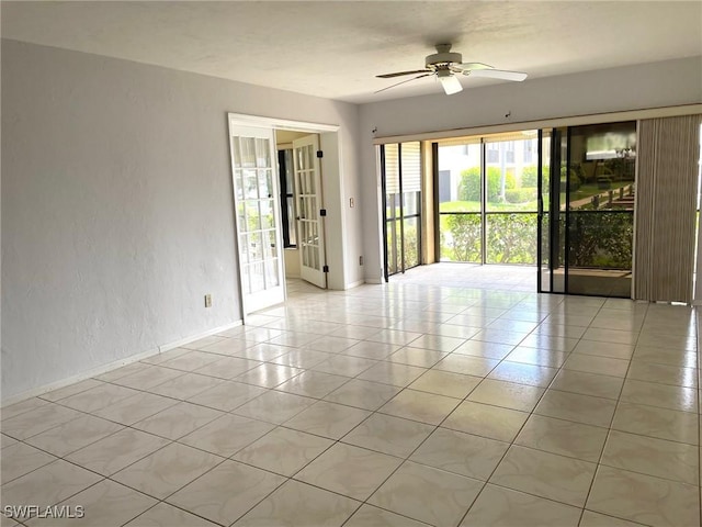 4703 SE 17th Pl Unit 105, Cape Coral, FL 33904 - empty room featuring a ceiling fan, baseboards, light tile patterned floors, and a textured wall