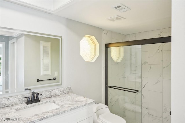 full bathroom with a marble finish shower, visible vents, toilet, and vanity