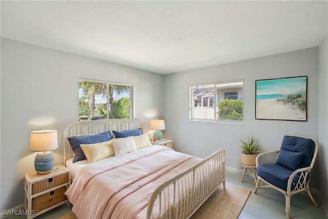 bedroom with baseboards and multiple windows