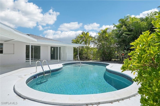 outdoor pool with a patio area