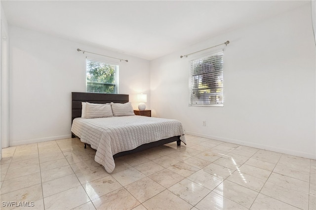 944 22nd Ave N, Naples, FL 34103 - bedroom featuring baseboards and light tile patterned flooring