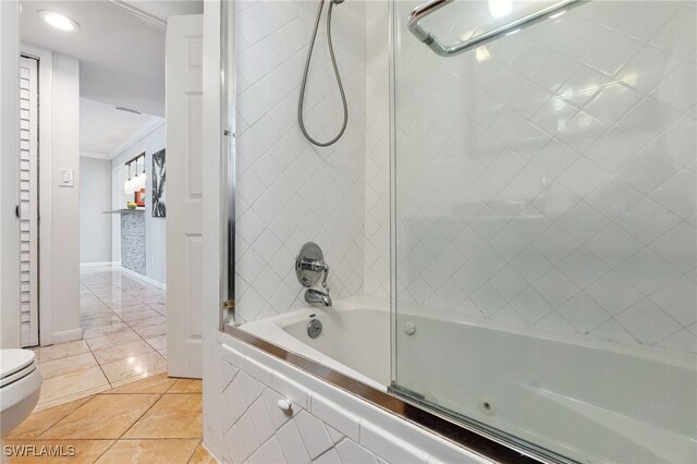 944 22nd Ave N, Naples, FL 34103 - full bathroom with tile patterned flooring, shower / washtub combination, toilet, and crown molding