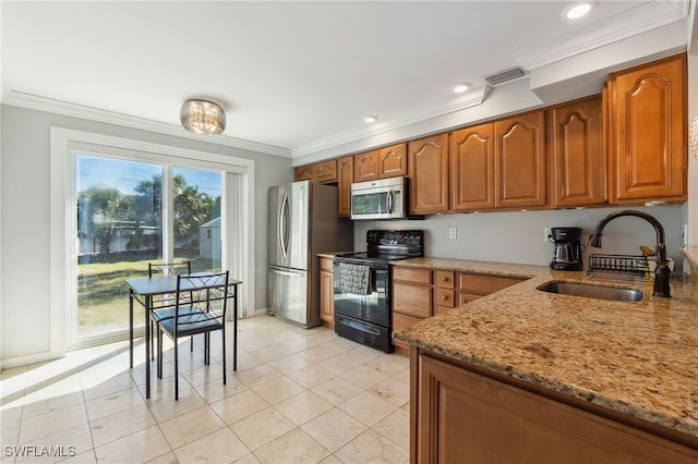 944 22nd Ave N, Naples, FL 34103 - kitchen with a sink, light stone countertops, appliances with stainless steel finishes, and brown cabinetry