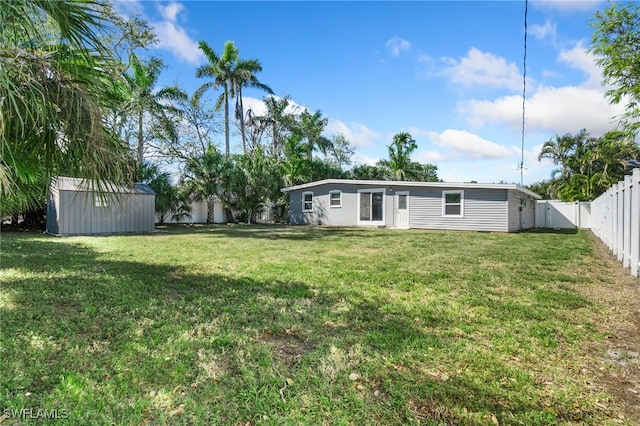 944 22nd Ave N, Naples, FL 34103 - view of yard with an outbuilding, a storage unit, and a fenced backyard