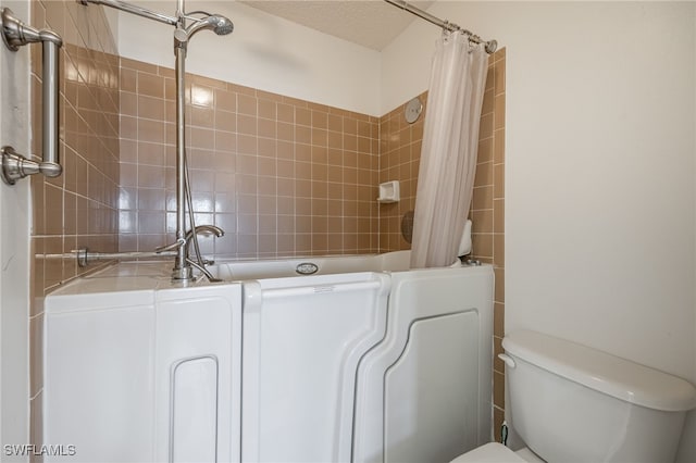 3458 Hancock Bridge Pkwy Unit 163, North Fort Myers, FL 33903 - bathroom featuring toilet, separate washer and dryer, tile walls, and a shower with curtain