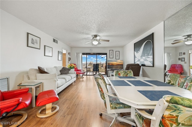 3458 Hancock Bridge Pkwy Unit 163, North Fort Myers, FL 33903 - dining area featuring visible vents, a ceiling fan, a textured ceiling, and wood finished floors
