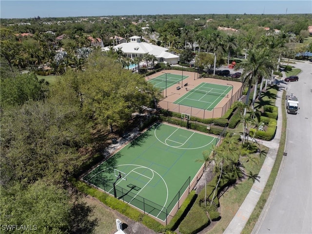 view of basketball court with a tennis court, community basketball court, and fence