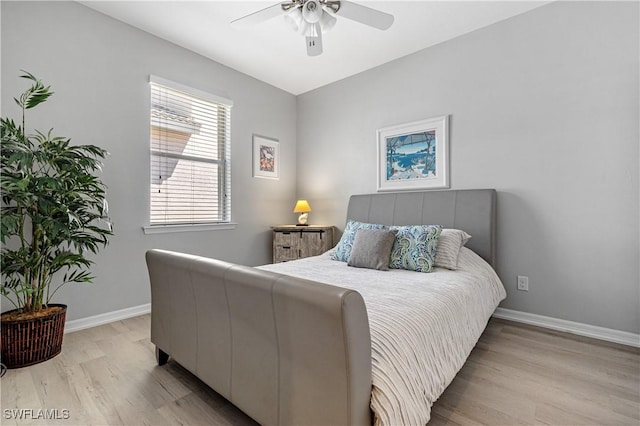 bedroom featuring a ceiling fan, wood finished floors, and baseboards