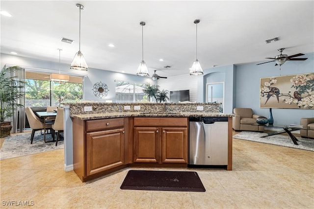 kitchen featuring visible vents, open floor plan, light stone counters, stainless steel dishwasher, and a sink