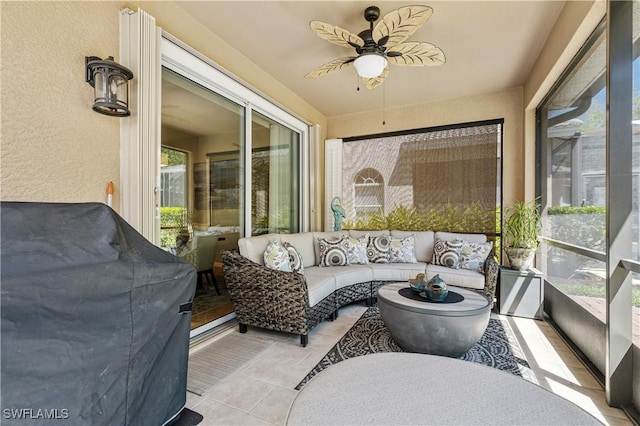 sunroom / solarium featuring ceiling fan