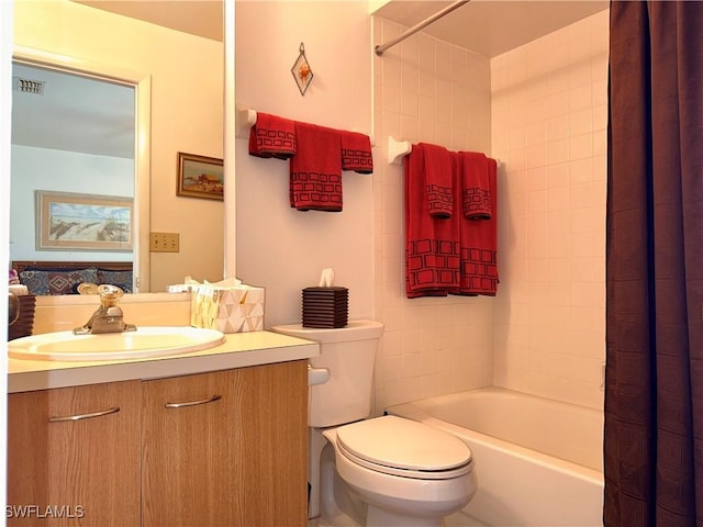 bathroom with visible vents, vanity, shower / tub combo, and toilet