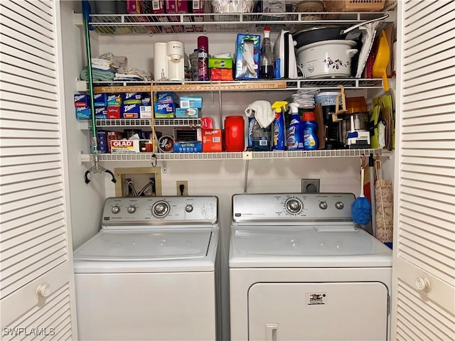 clothes washing area featuring separate washer and dryer and laundry area