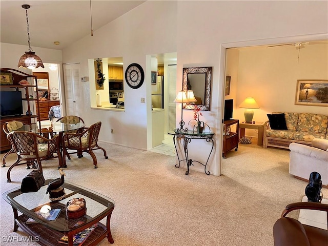 living room featuring carpet floors and high vaulted ceiling