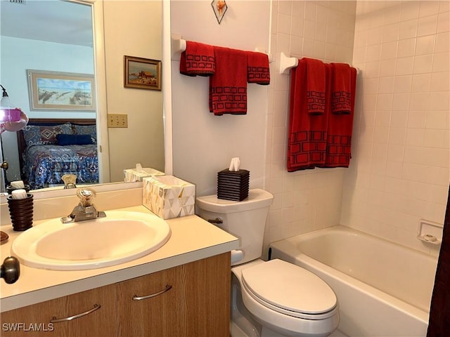 bathroom with toilet, ensuite bath, and vanity