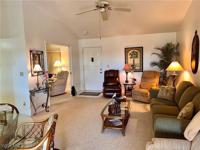 living area featuring a ceiling fan, lofted ceiling, and carpet