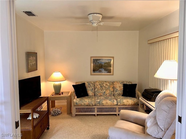 carpeted living room with visible vents and a ceiling fan