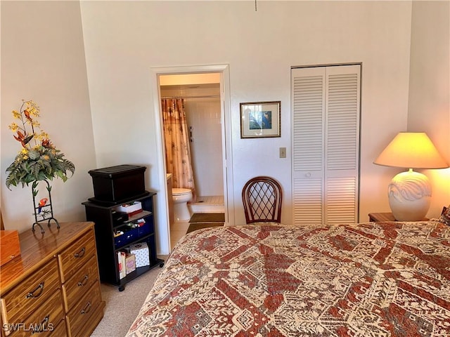 bedroom featuring a closet, light colored carpet, and ensuite bathroom