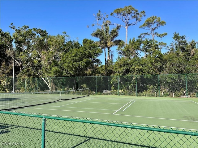 view of sport court featuring fence