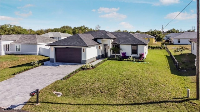 ranch-style home with a front yard, decorative driveway, an attached garage, and stucco siding