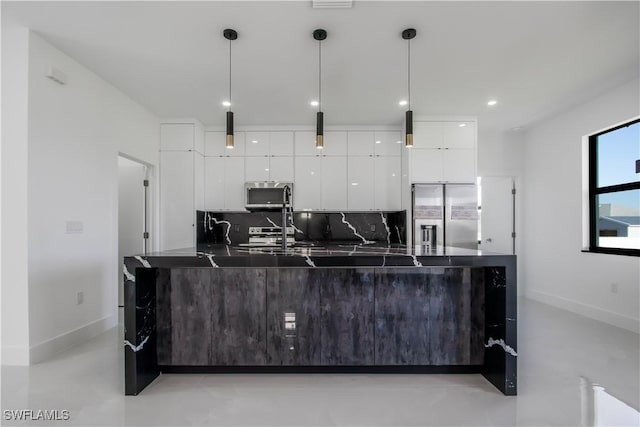 kitchen with dark countertops, decorative backsplash, stainless steel appliances, white cabinetry, and modern cabinets