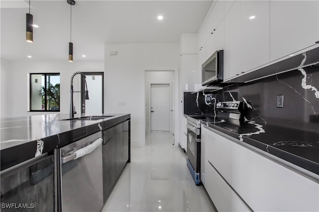 kitchen with a sink, stainless steel appliances, white cabinets, pendant lighting, and modern cabinets