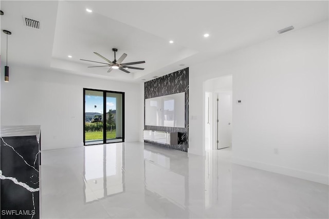 living room featuring visible vents, recessed lighting, a tray ceiling, and ceiling fan