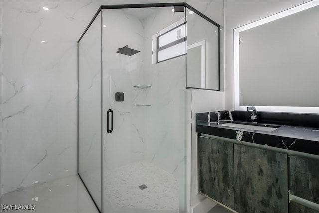 bathroom featuring vanity and a marble finish shower