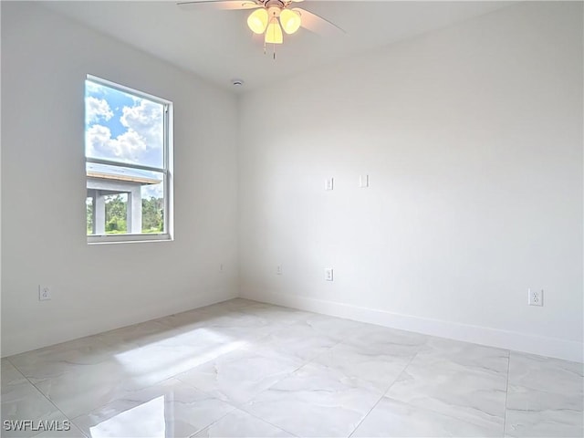 650 Kraft St, Lehigh Acres, FL 33974 - empty room with light marble finish flooring, ceiling fan, and baseboards