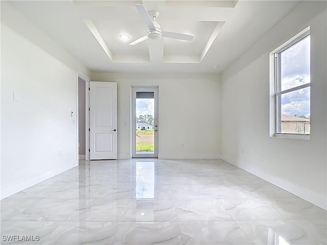 650 Kraft St, Lehigh Acres, FL 33974 - empty room featuring light marble finish floors, ceiling fan, and baseboards
