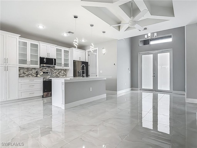 650 Kraft St, Lehigh Acres, FL 33974 - kitchen with appliances with stainless steel finishes, baseboards, an island with sink, white cabinets, and recessed lighting