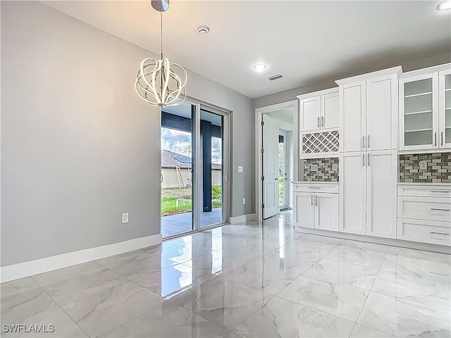 650 Kraft St, Lehigh Acres, FL 33974 - unfurnished dining area featuring baseboards, light marble finish floors, a chandelier, and recessed lighting
