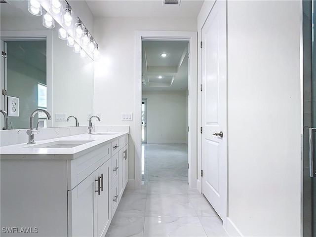 650 Kraft St, Lehigh Acres, FL 33974 - bathroom featuring double vanity, baseboards, and marble finish floors