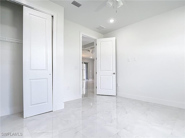 650 Kraft St, Lehigh Acres, FL 33974 - unfurnished bedroom featuring light marble finish floors, baseboards, a closet, ceiling fan, and recessed lighting