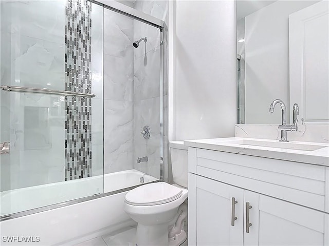 650 Kraft St, Lehigh Acres, FL 33974 - bathroom with toilet, vanity, and shower / bath combination with glass door