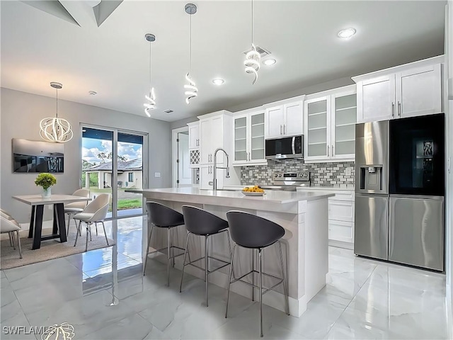 650 Kraft St, Lehigh Acres, FL 33974 - kitchen featuring stainless steel appliances, a sink, light countertops, backsplash, and light marble finish floors