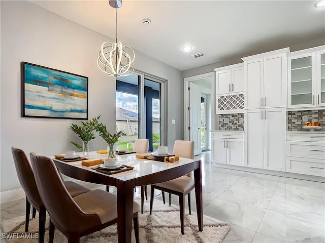 650 Kraft St, Lehigh Acres, FL 33974 - dining space with light marble finish flooring, a chandelier, baseboards, and recessed lighting