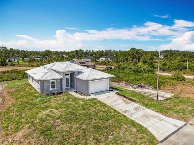 650 Kraft St, Lehigh Acres, FL 33974 - view of front of property with an attached garage, driveway, a front yard, and stucco siding