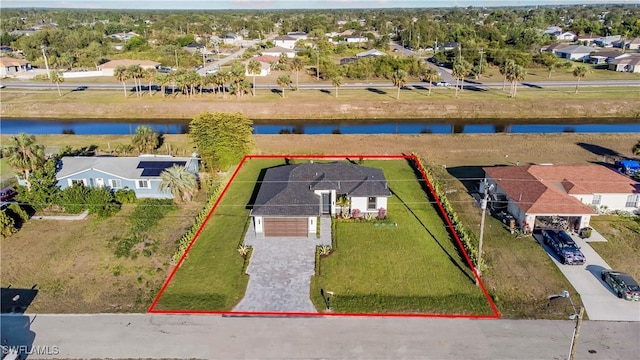 drone / aerial view featuring a residential view and a water view