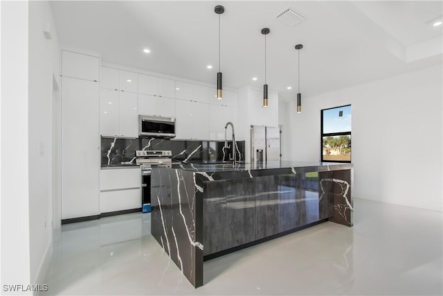 kitchen with a sink, decorative backsplash, stainless steel appliances, white cabinetry, and modern cabinets