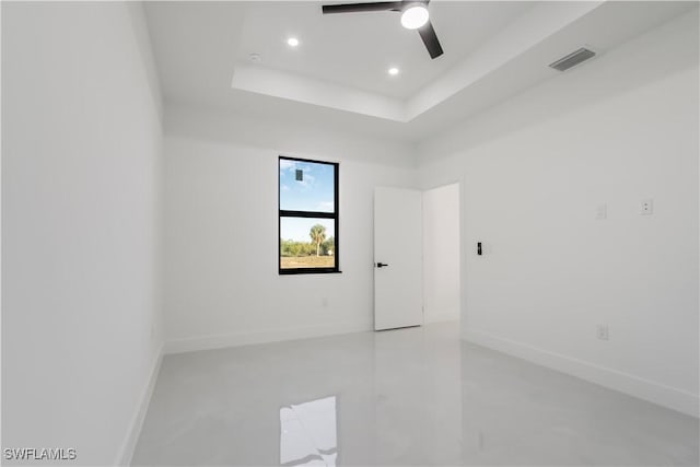 spare room featuring visible vents, ceiling fan, baseboards, a tray ceiling, and recessed lighting