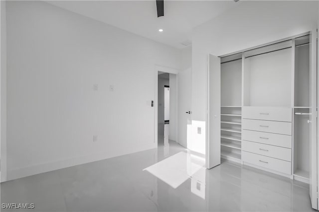 unfurnished bedroom with a ceiling fan, recessed lighting, and a closet