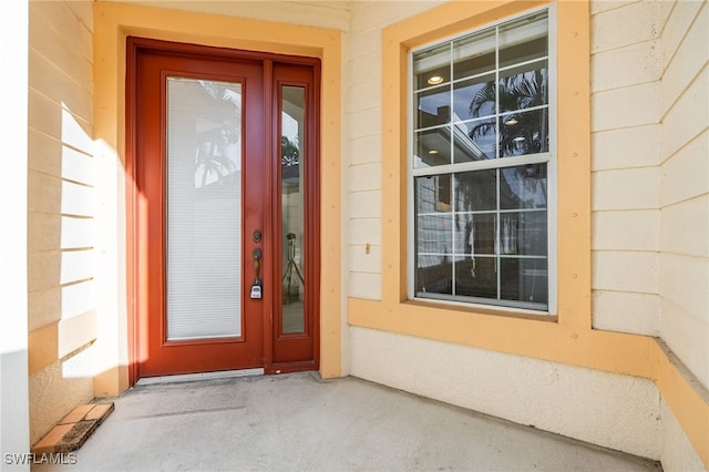 entrance to property featuring concrete block siding