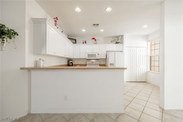 kitchen featuring visible vents, recessed lighting, a peninsula, white appliances, and white cabinetry