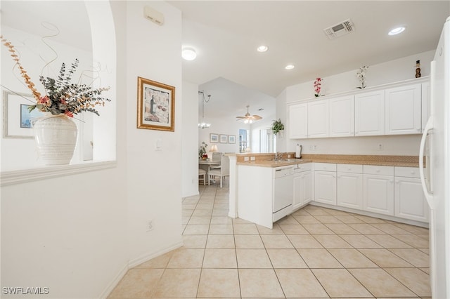 kitchen with white appliances, light tile patterned floors, visible vents, a peninsula, and white cabinetry