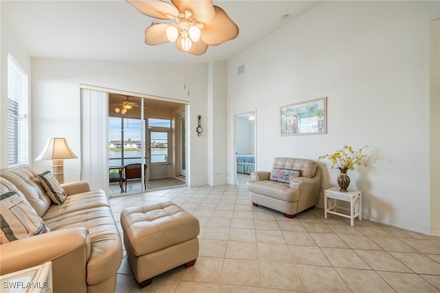 living area featuring light tile patterned floors, high vaulted ceiling, a wealth of natural light, and ceiling fan