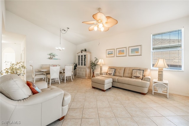 living room with light tile patterned floors, ceiling fan with notable chandelier, baseboards, and vaulted ceiling